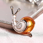 White Austrian Crystal Enamelled Snail Brooch in Gold Tone