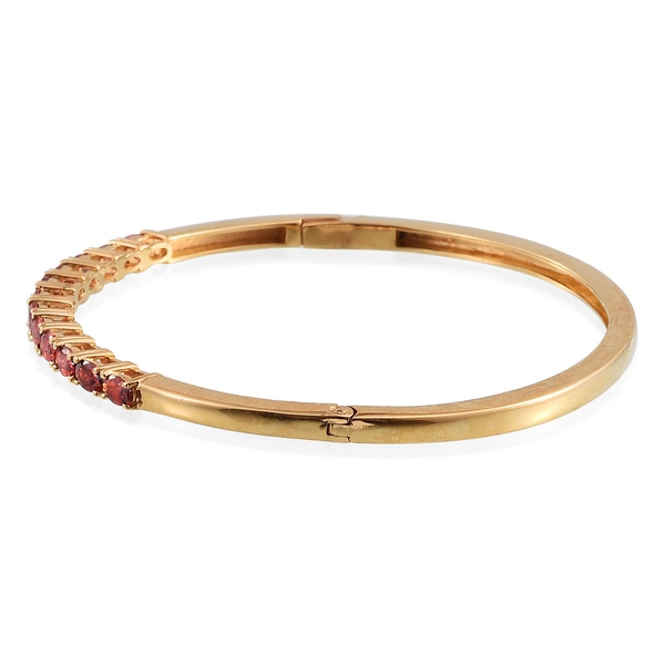 Simulated Ruby (Ovl) Bangle (Size 7.5) in ION Plated 18K Yellow Gold Bond 3.500 Ct.
