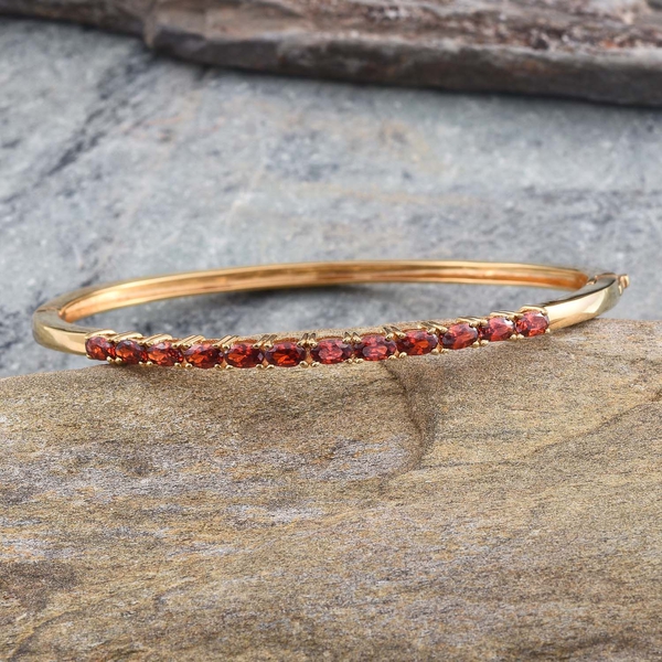 Simulated Ruby (Ovl) Bangle (Size 7.5) in ION Plated 18K Yellow Gold Bond 3.500 Ct.